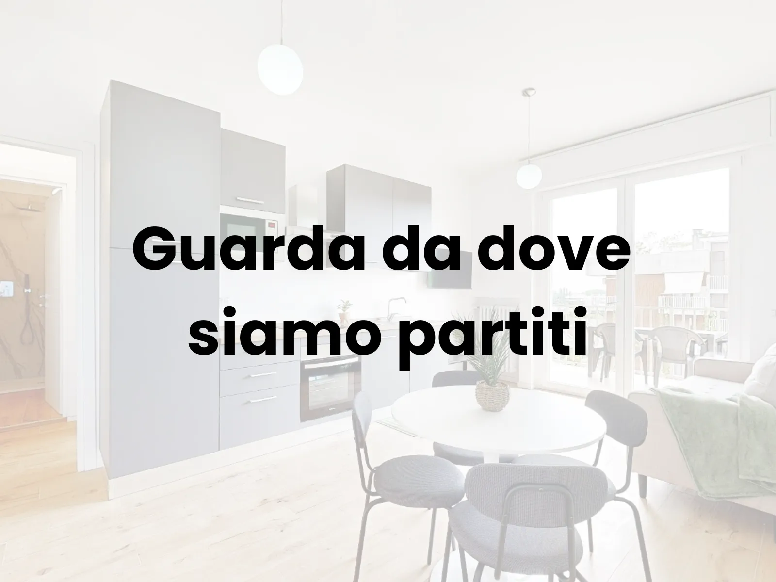 Bilocale open space con cucina grigio antracite e parquet rovere